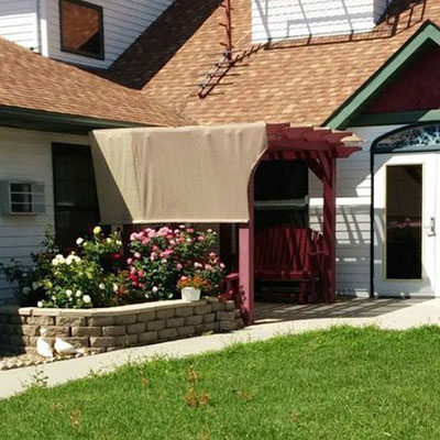 Exterior shot of The Victorian with pergola and flower bed